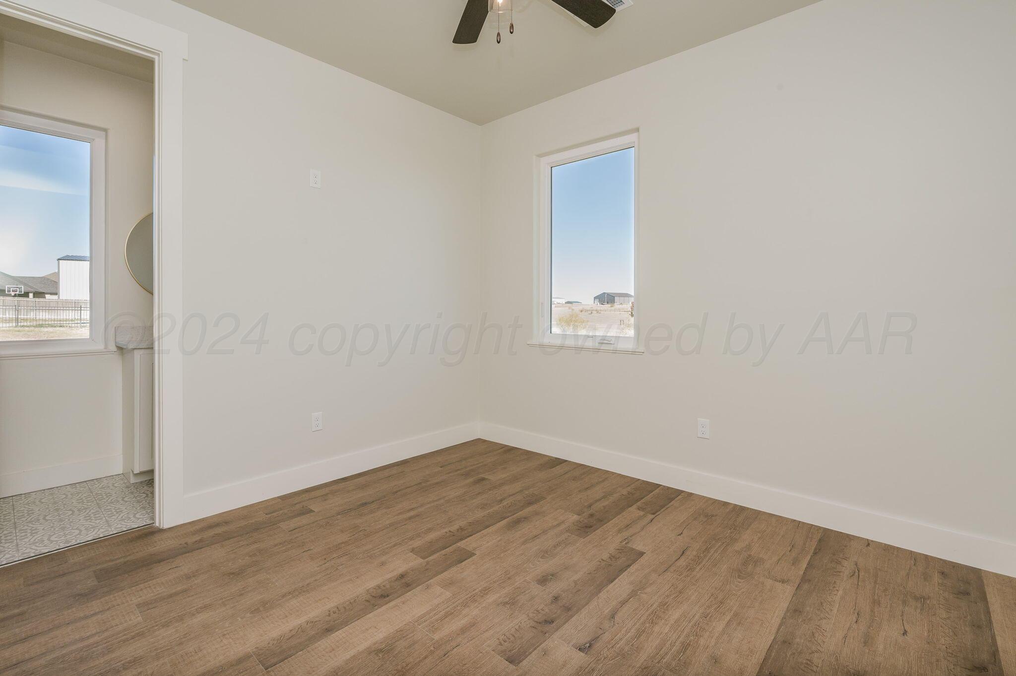 13351 Genevieve's Way Amarillo, TX 79118 - Photo 23 of 35 an empty room with a window and a ceiling fan