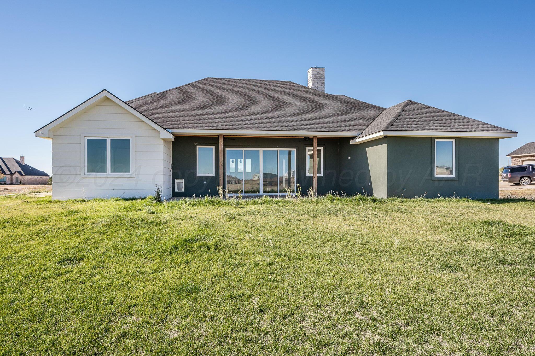 13351 Genevieve's Way Amarillo, TX 79118 - Photo 32 of 35 a brick house with a yard