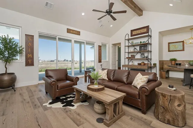 a living room with furniture and a wooden floor