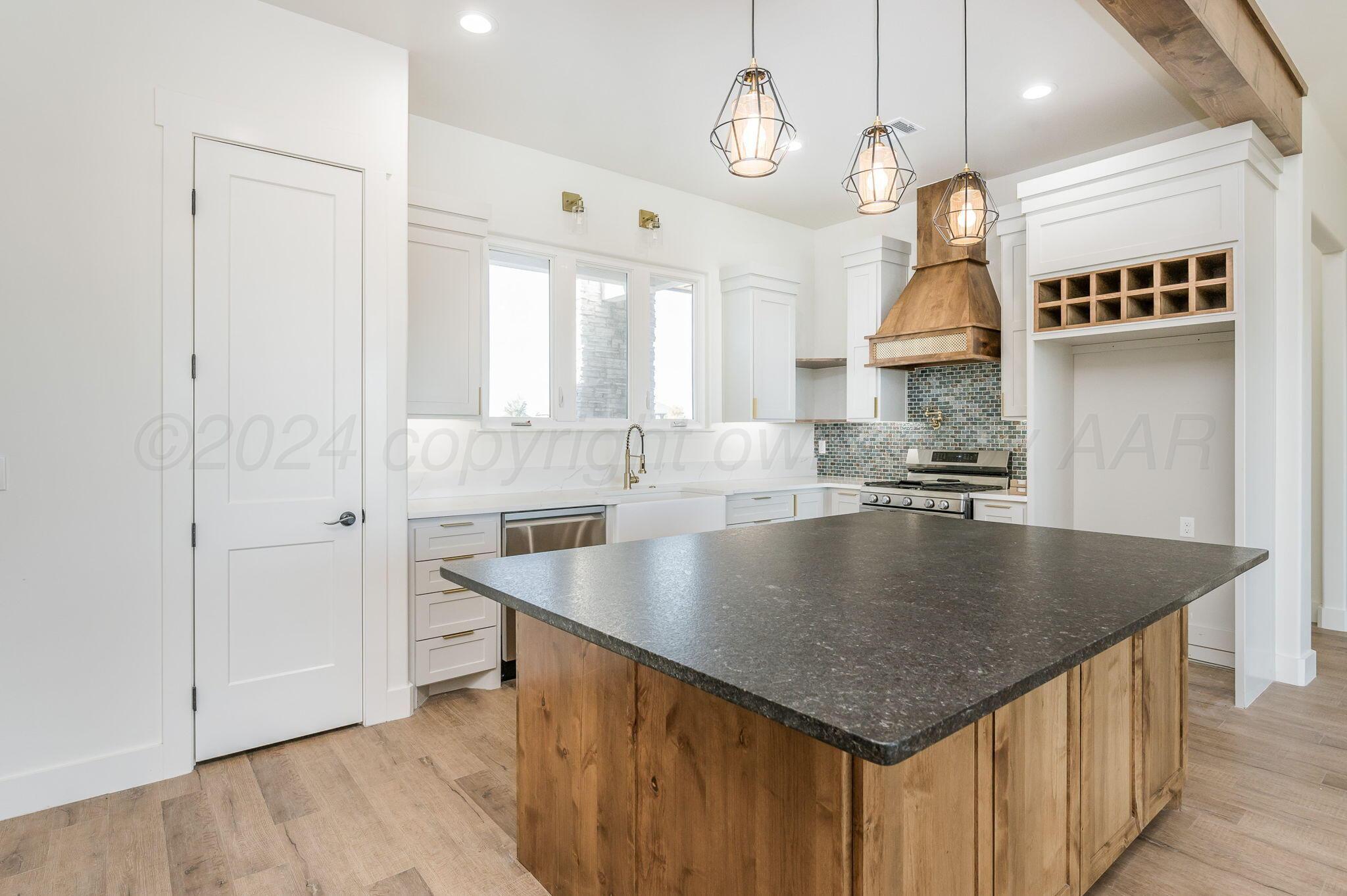 13351 Genevieve's Way Amarillo, TX 79118 - Photo 10 of 35 an open kitchen with a table chairs and a chandelier