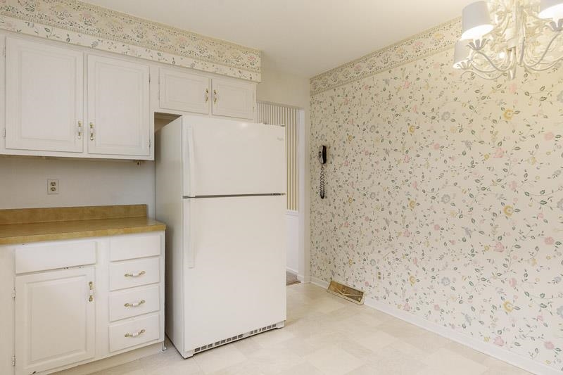5792 Haddon Place Rockford, IL 61114 - Photo 16 of 47 a white refrigerator freezer sitting inside of a kitchen