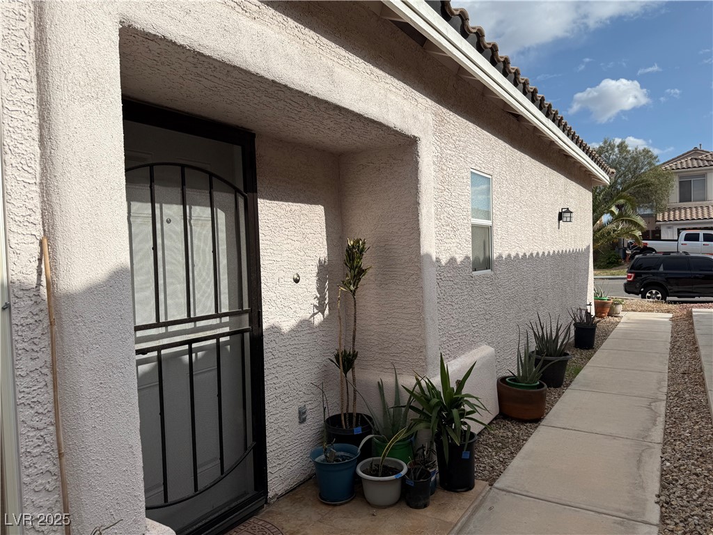 7062 Russell Ranch Avenue Las Vegas, NV 89113 - Photo 6 of 32 View of home's exterior with stucco siding
