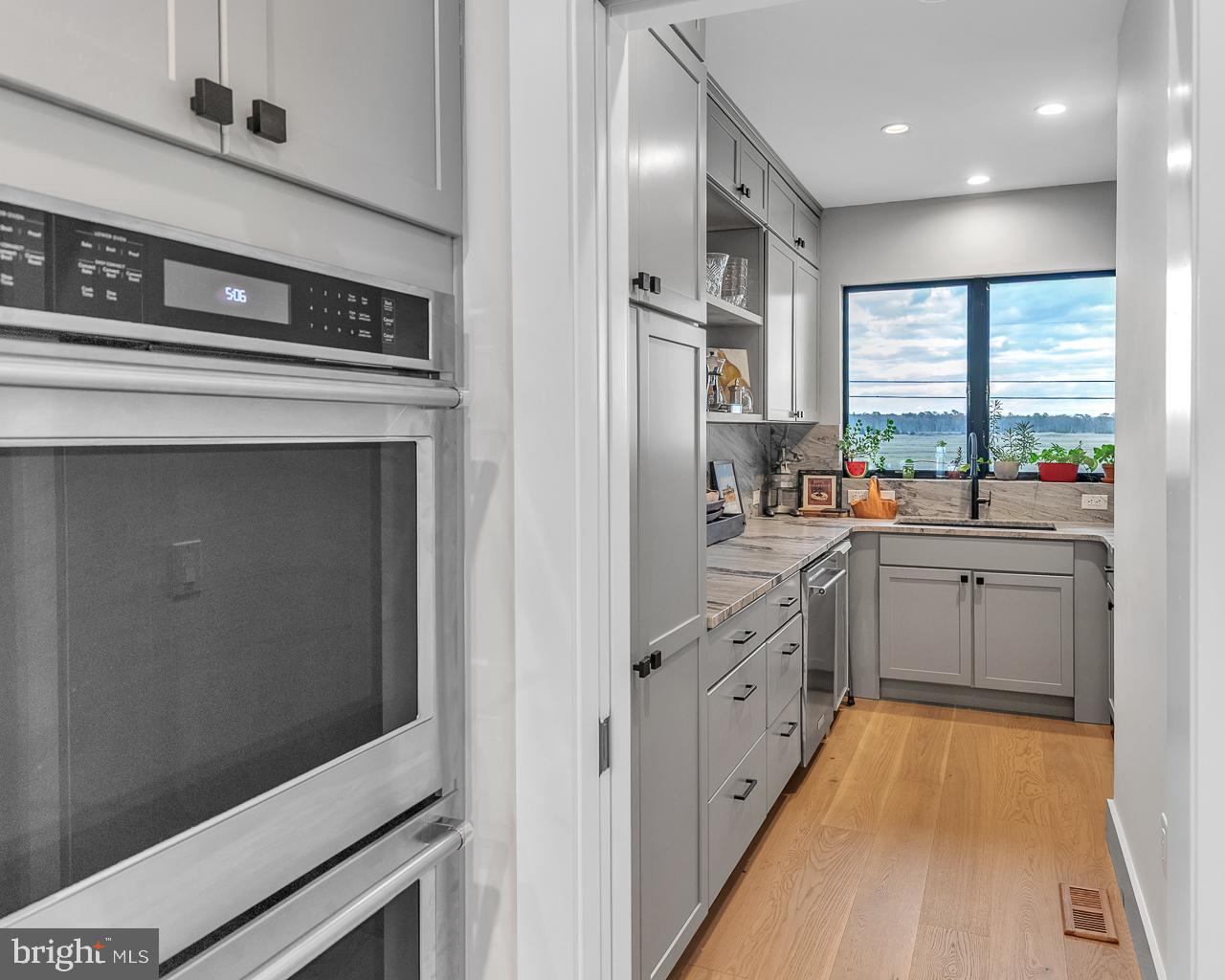 637 Cedar Run Dock Road West Creek, NJ 08092 - Photo 11 of 50 a kitchen with stainless steel appliances sink a microwave and cabinets