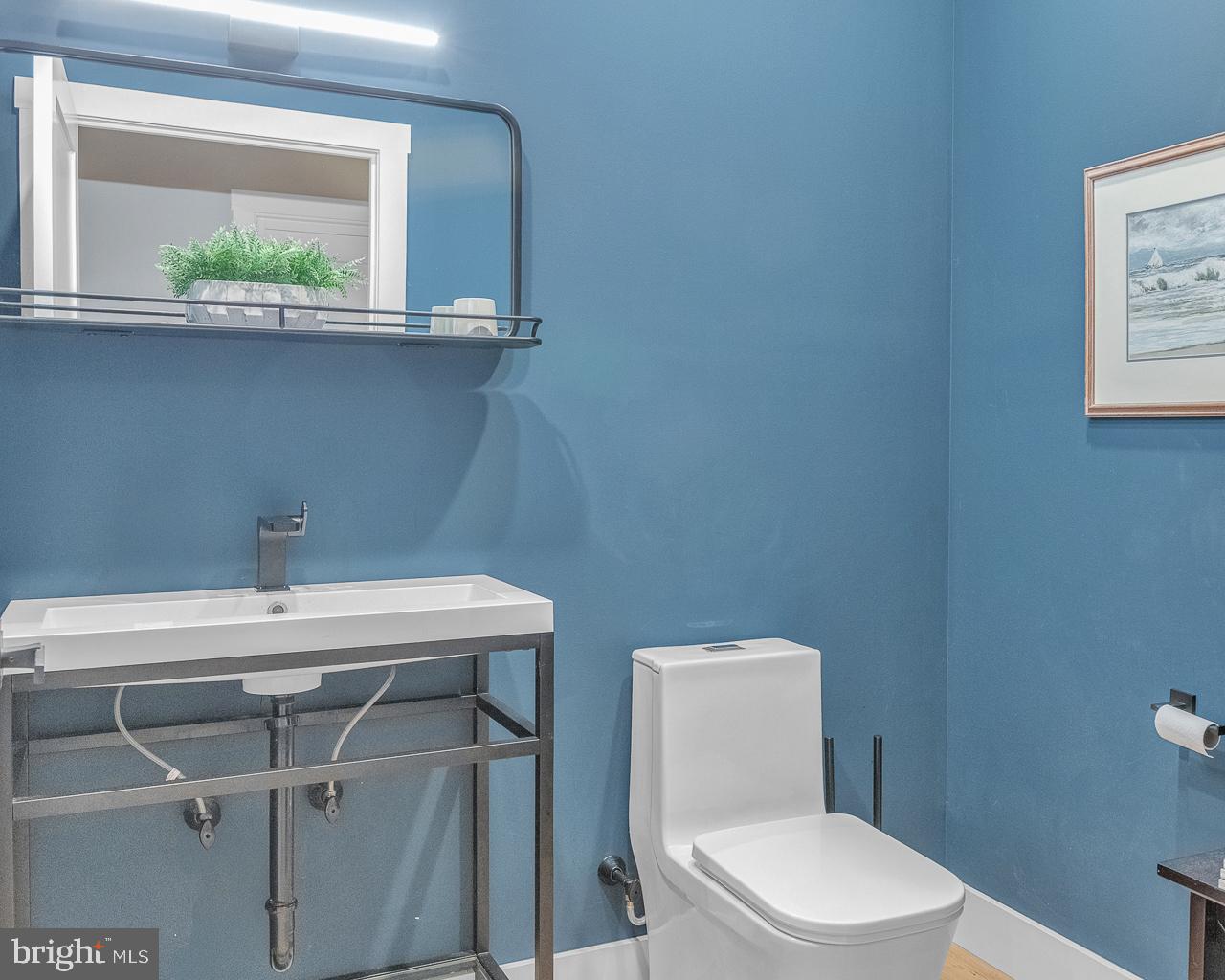 637 Cedar Run Dock Road West Creek, NJ 08092 - Photo 15 of 50 a bathroom with a toilet a sink and a window