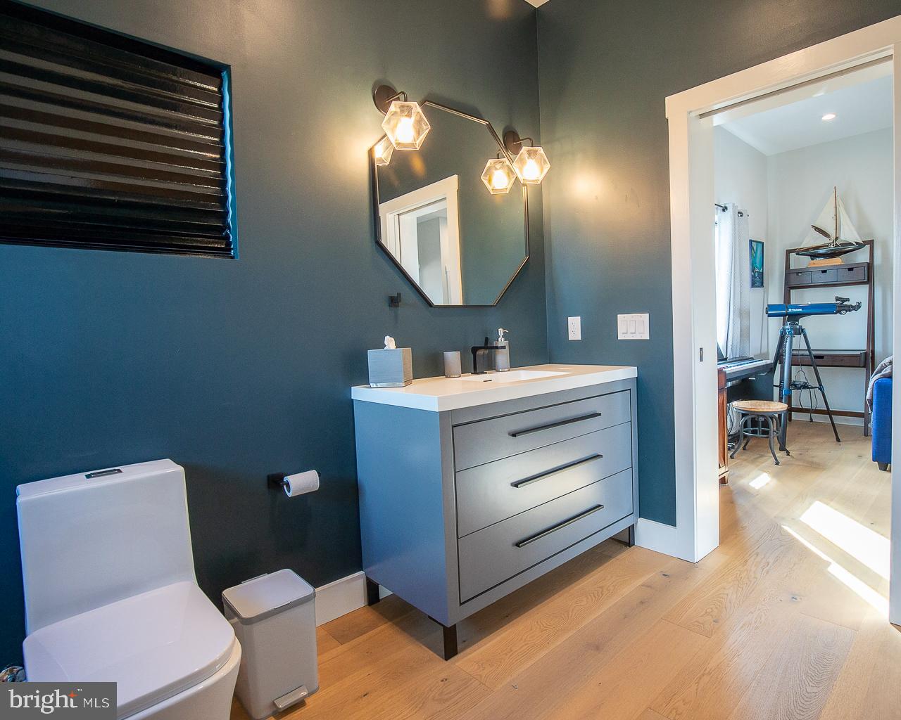 637 Cedar Run Dock Road West Creek, NJ 08092 - Photo 29 of 50 a bathroom with a toilet sink and mirror