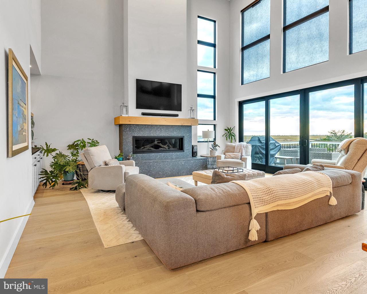 637 Cedar Run Dock Road West Creek, NJ 08092 - Photo 4 of 50 a living room with furniture a flat screen tv and a fireplace
