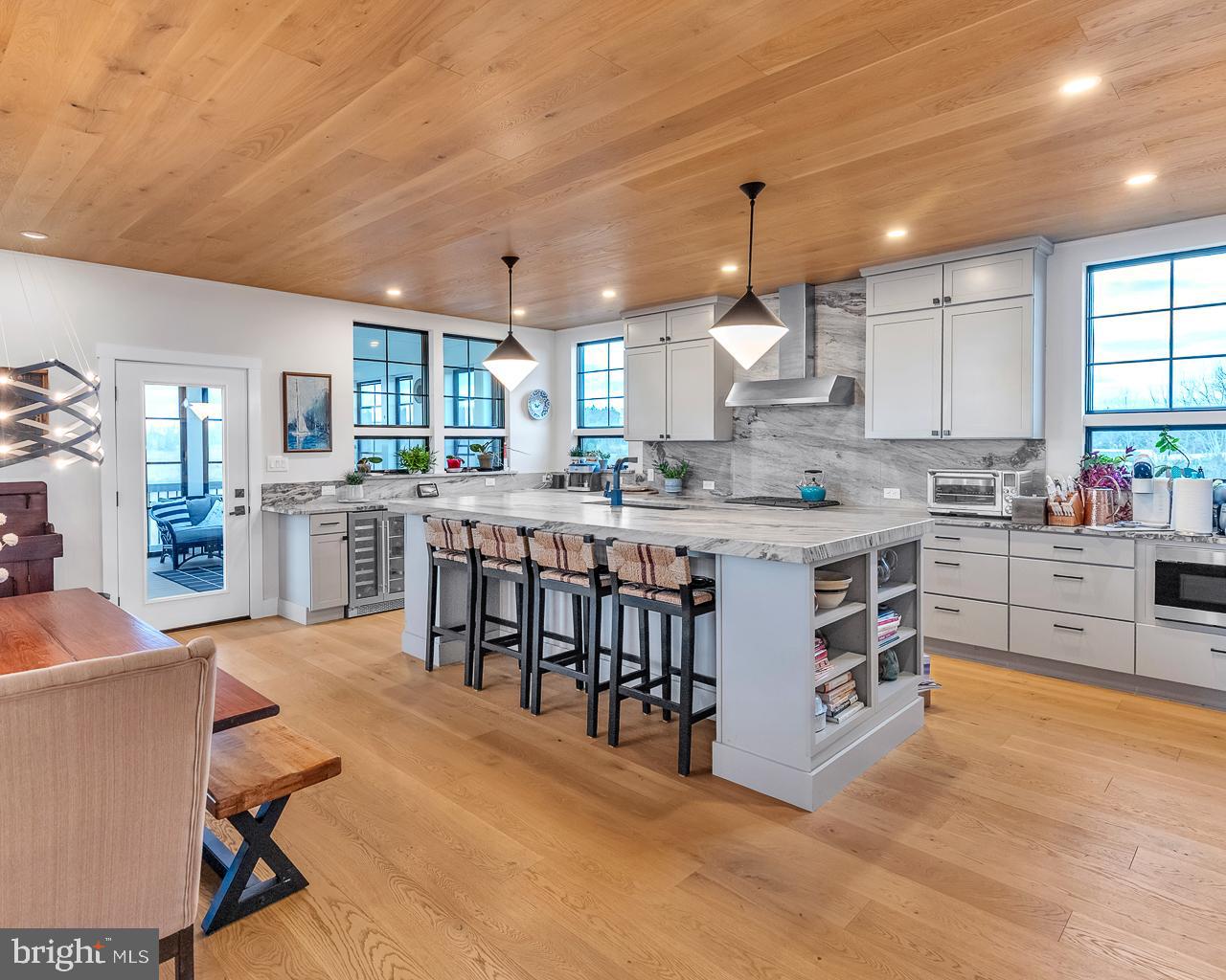 637 Cedar Run Dock Road West Creek, NJ 08092 - Photo 7 of 50 a large kitchen with kitchen island a stove a sink a dining table and chairs