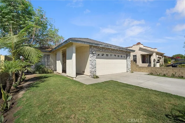 a big white house with a big yard and large tree