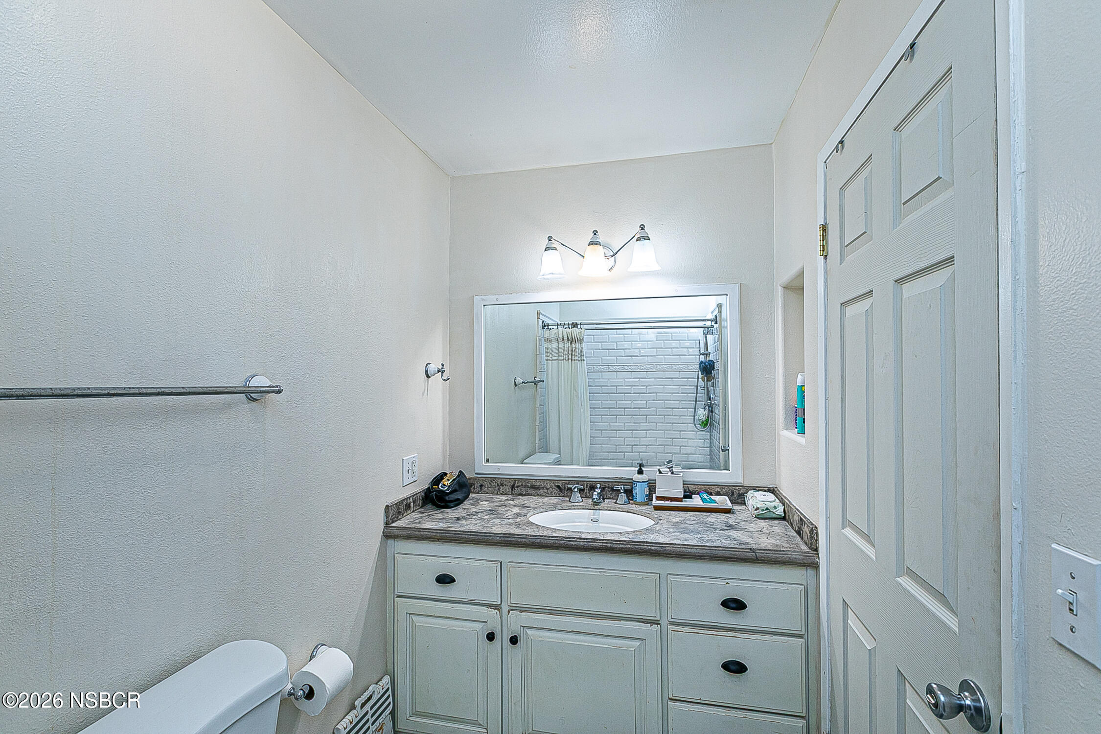 712 Pebble Beach Place Santa Maria, CA 93454 - Photo 19 of 31 a bathroom with a granite countertop sink a toilet and a mirror