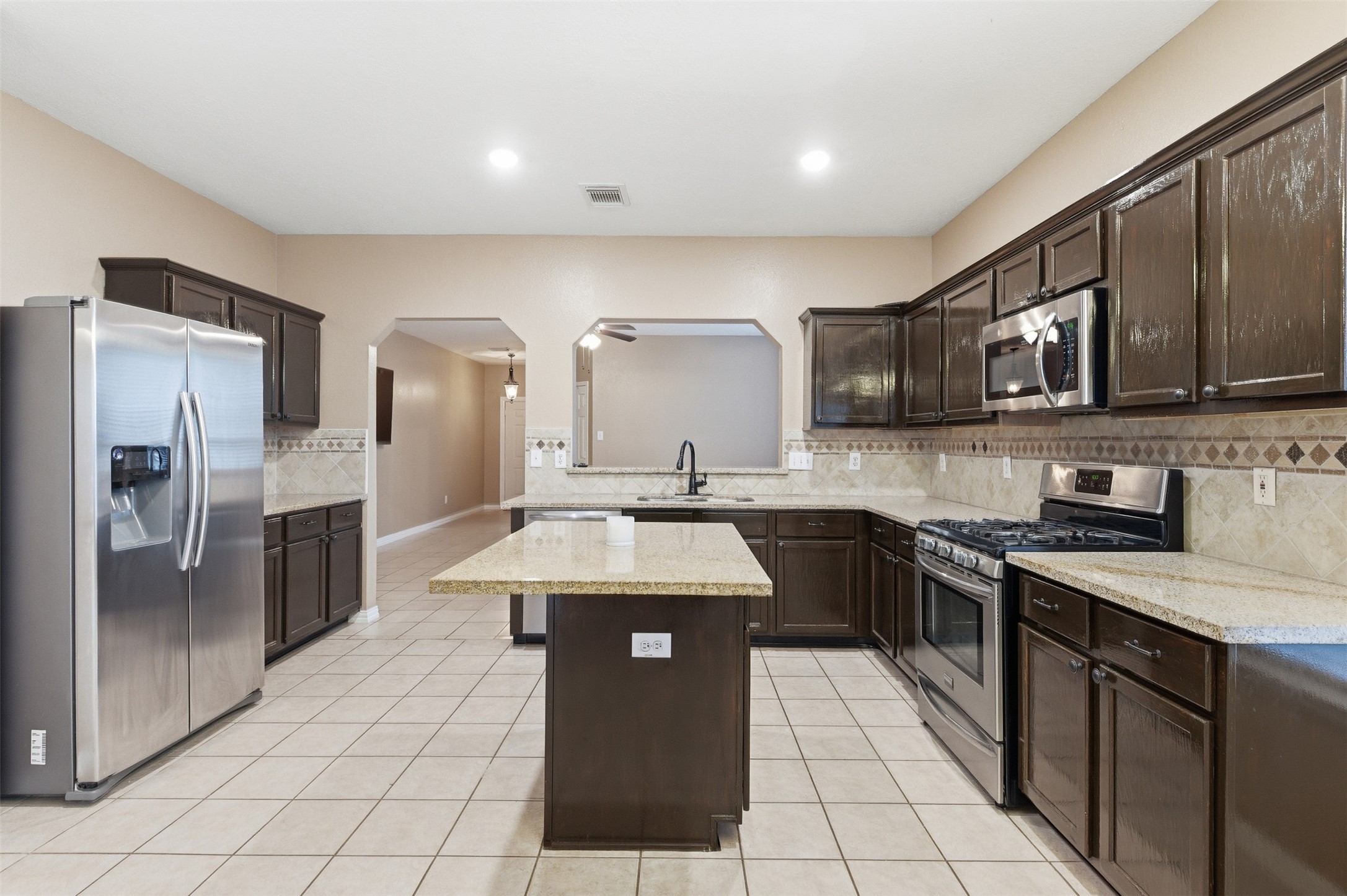 19710 Yaupon Ranch Drive Cypress, TX 77433 - Photo 15 of 34 a kitchen with stainless steel appliances granite countertop a sink stove and refrigerator