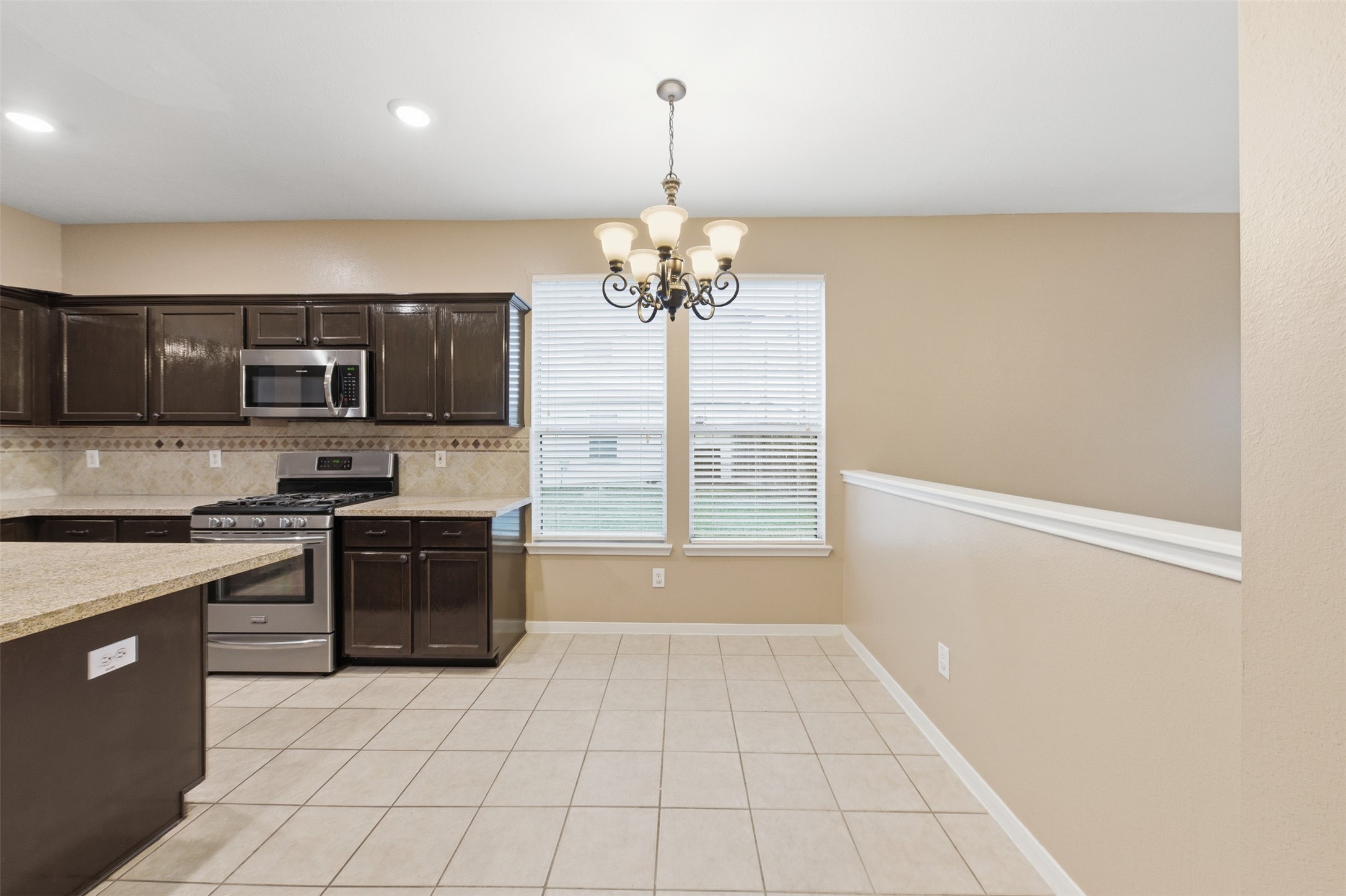 19710 Yaupon Ranch Drive Cypress, TX 77433 - Photo 16 of 34 a kitchen with a refrigerator a stove top oven a sink and a window