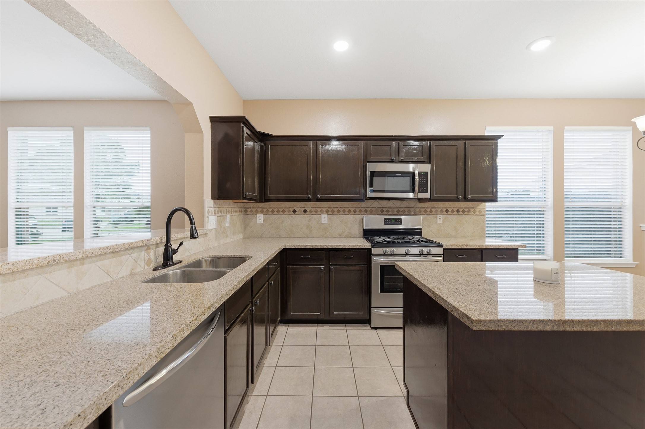 19710 Yaupon Ranch Drive Cypress, TX 77433 - Photo 17 of 34 a kitchen with stainless steel appliances granite countertop a sink stove and refrigerator