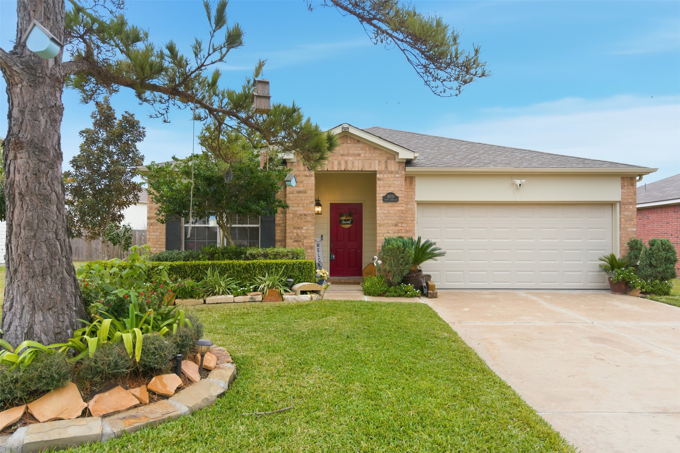 19710 Yaupon Ranch Drive Cypress, TX 77433 - Photo 2 of 34 a front view of a house with a yard and garage