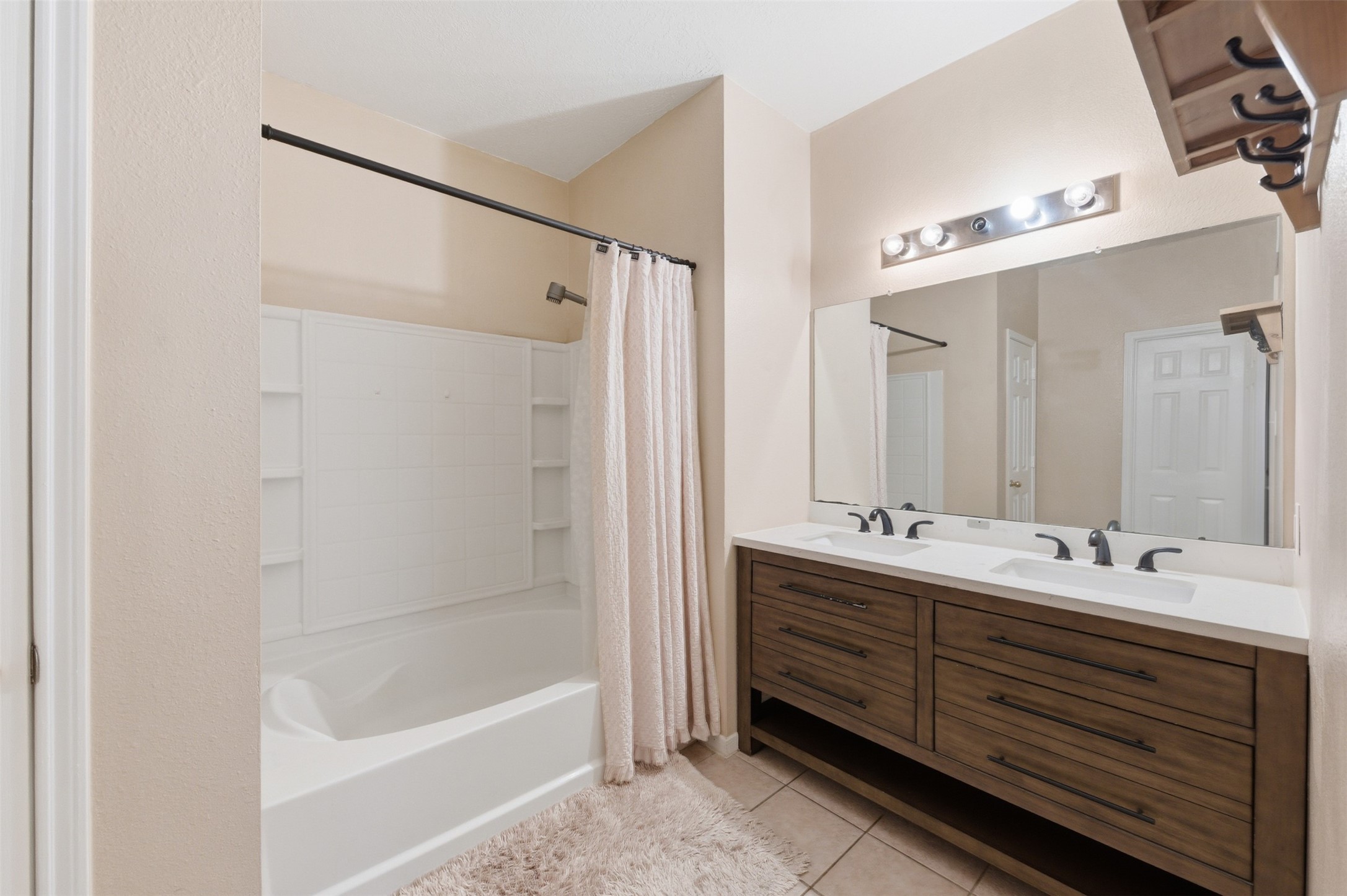 19710 Yaupon Ranch Drive Cypress, TX 77433 - Photo 22 of 34 a bathroom with a double vanity sink a large mirror and shower