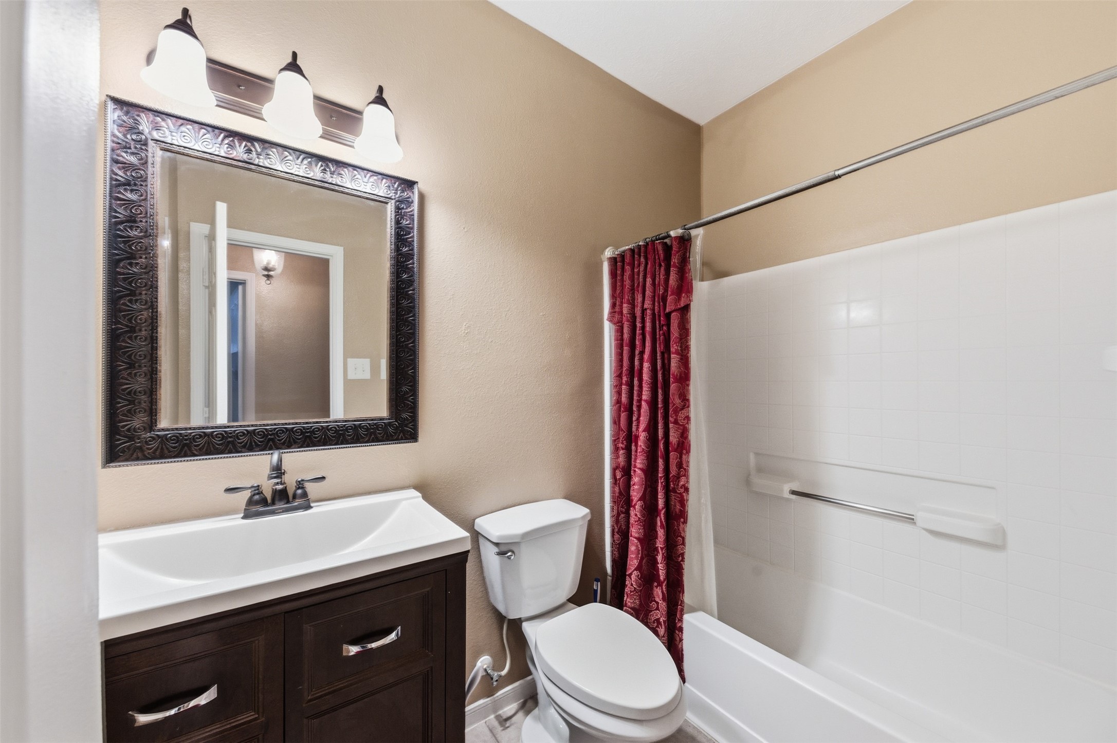 19710 Yaupon Ranch Drive Cypress, TX 77433 - Photo 30 of 34 a bathroom with a granite countertop sink toilet a mirror and shower