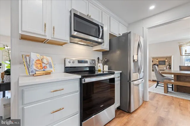 a kitchen with stainless steel appliances granite countertop a refrigerator stove and microwave