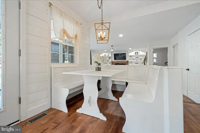 a living room with furniture a fireplace and a chandelier
