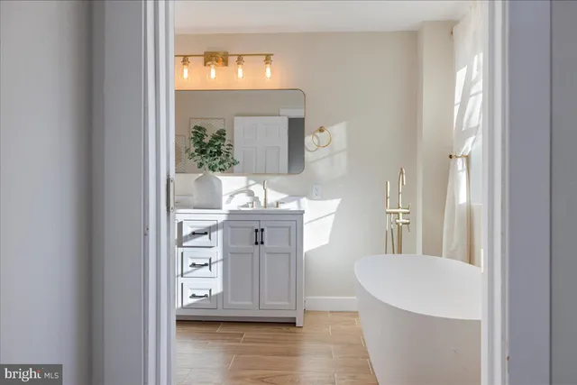 a bathroom with a sink vanity and a mirror