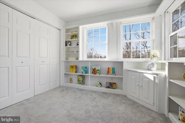 a view of kitchen with wooden floor and cabinets