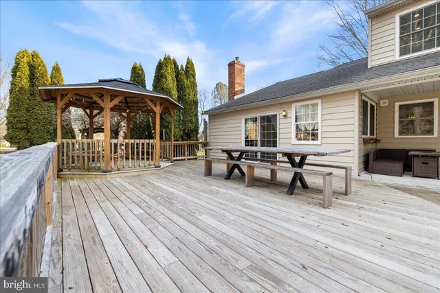 a view of a deck with table and chairs with wooden floor and fence