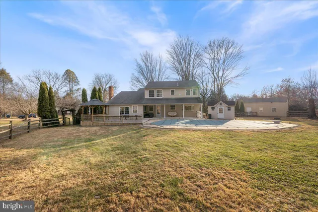 a front view of a building with a garden and fountain