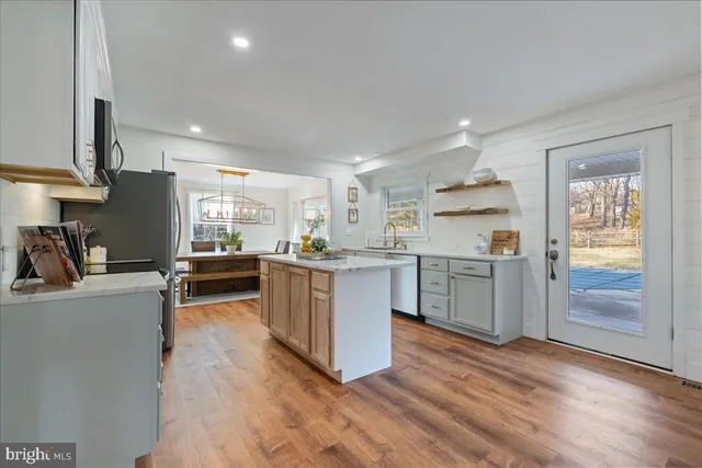 a kitchen with a refrigerator and a stove top oven