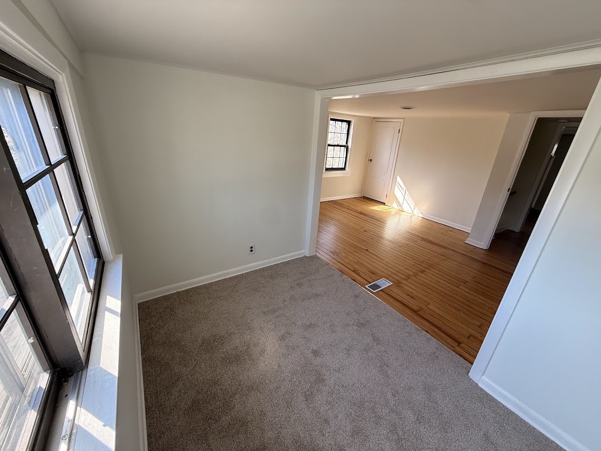 18404 Dixie Highway Homewood, IL 60430 - Photo 17 of 20 a view of an empty room with wooden floor and a window