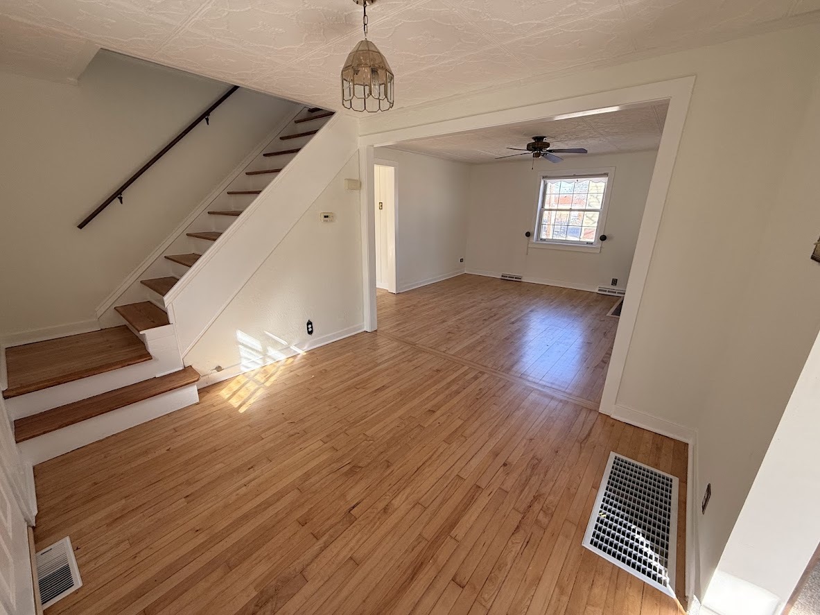 18404 Dixie Highway Homewood, IL 60430 - Photo 4 of 20 a view of an empty room with wooden floor and staircase