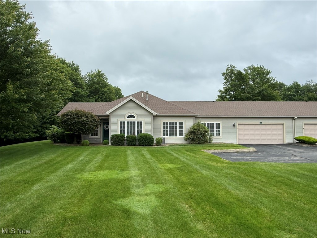 5645 Clingan Road, Unit 2D Struthers, OH 44471 - Photo 2 of 50 Single story home with driveway, a garage, and a front lawn