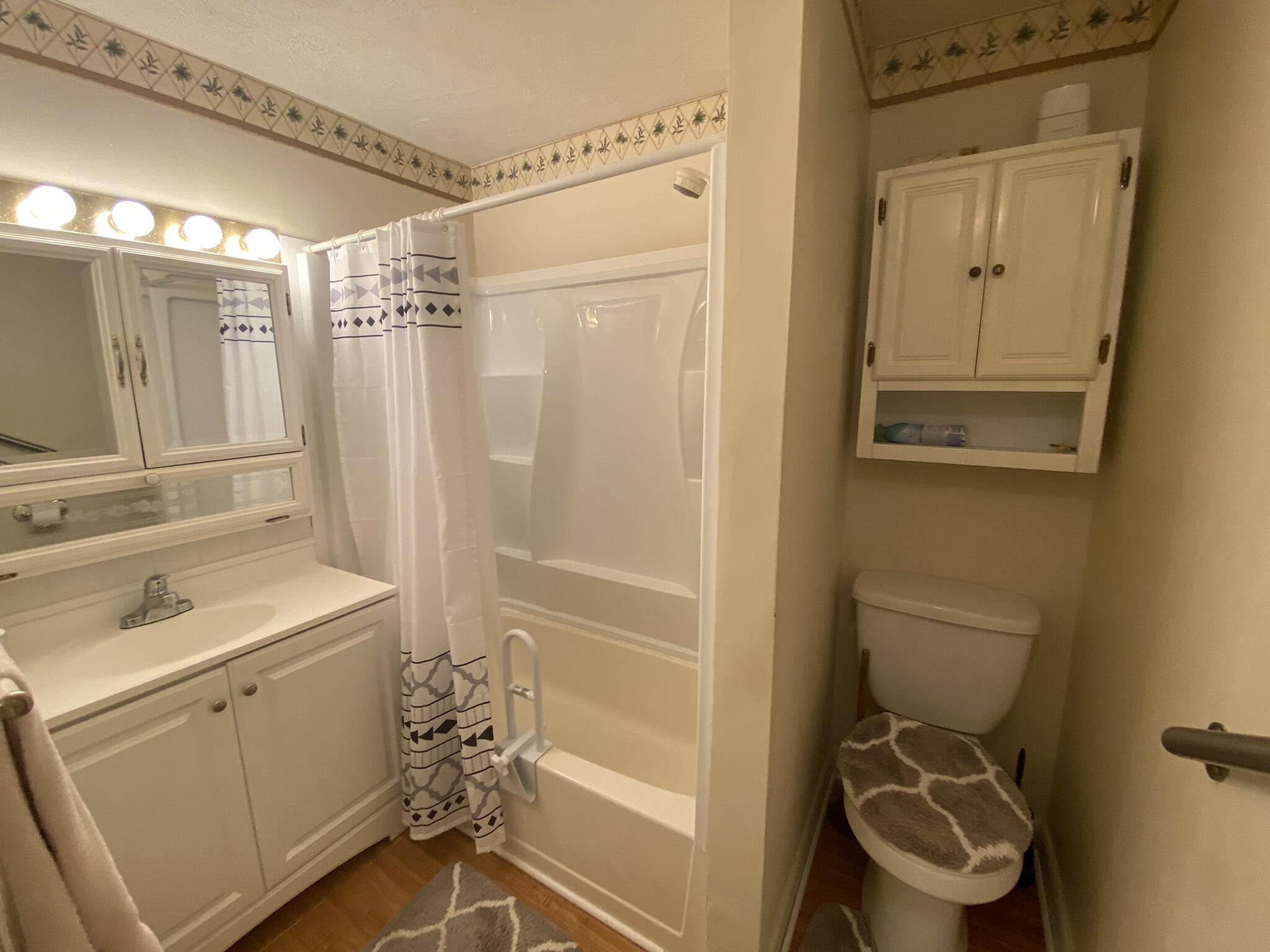 1101 25th Street Okeechobee, FL 34974 - Photo 14 of 28 a bathroom with a sink a toilet and shower