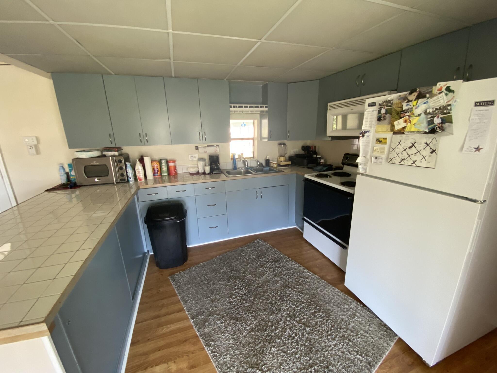 1101 25th Street Okeechobee, FL 34974 - Photo 15 of 28 a kitchen with stainless steel appliances granite countertop a sink stove and refrigerator