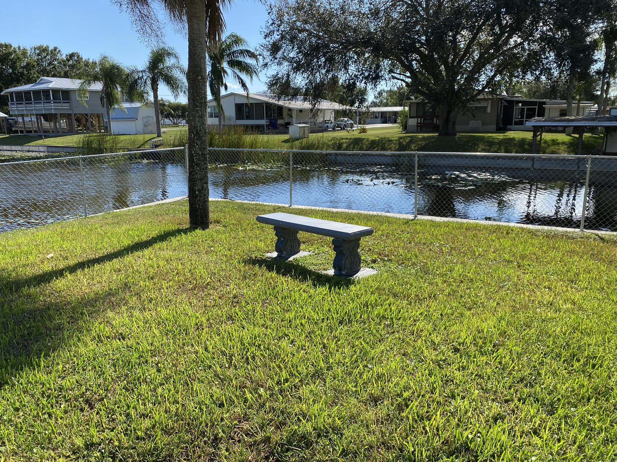 1101 25th Street Okeechobee, FL 34974 - Photo 19 of 28 a view of a lake with a bench