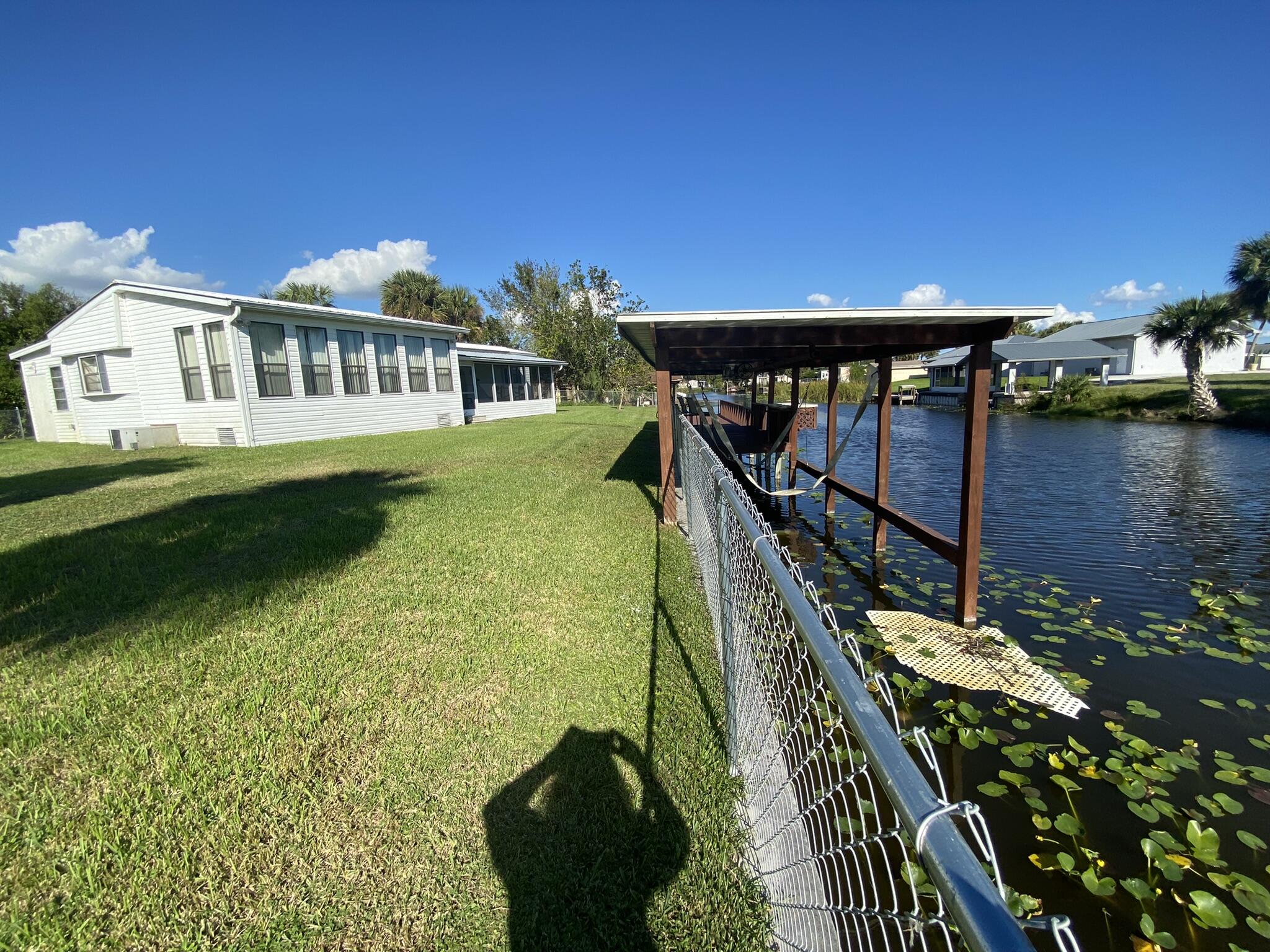 1101 25th Street Okeechobee, FL 34974 - Photo 23 of 28 a balcony with wooden floor table and chairs