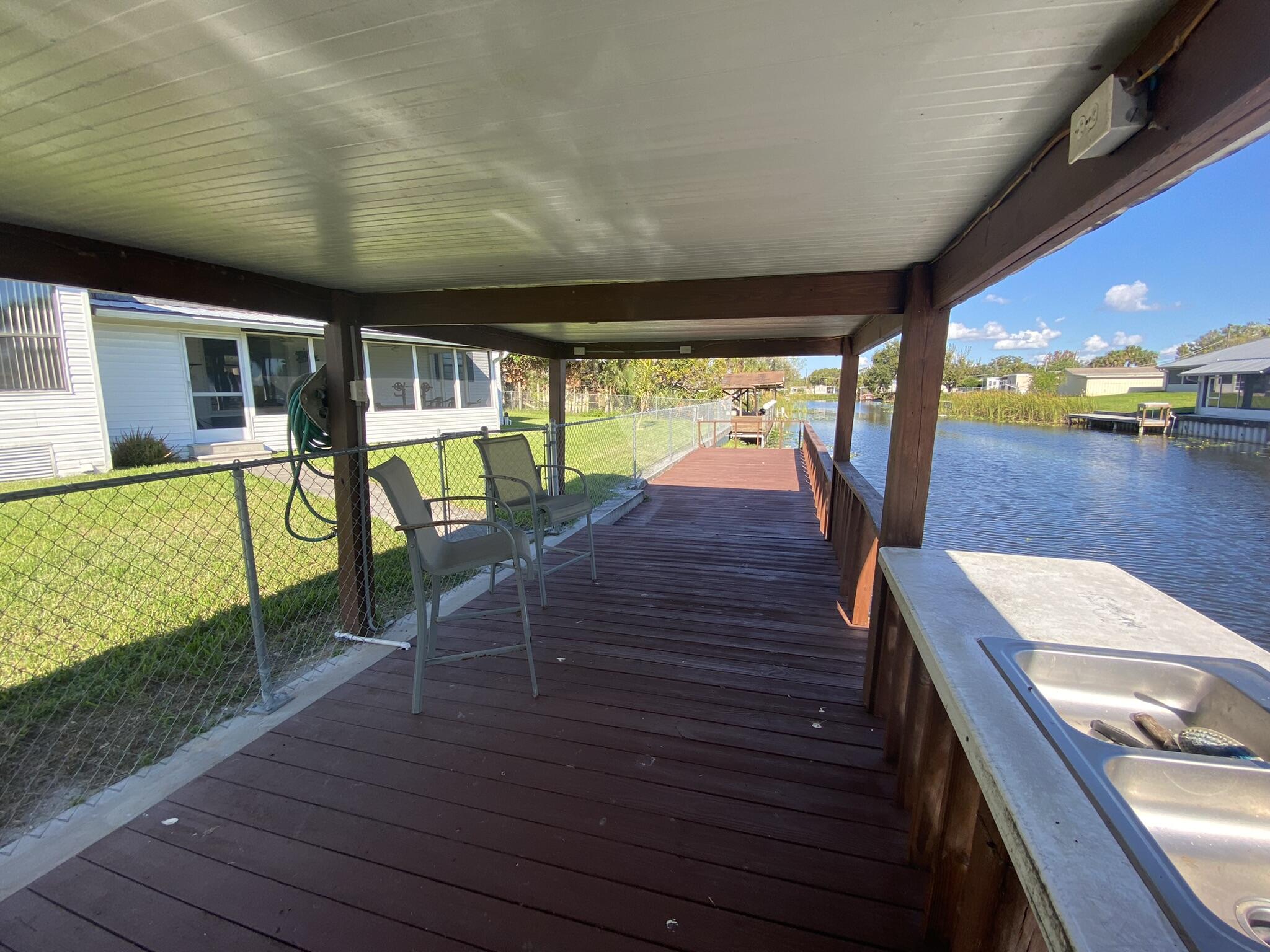 1101 25th Street Okeechobee, FL 34974 - Photo 26 of 28 a view of a living room and balcony with furniture