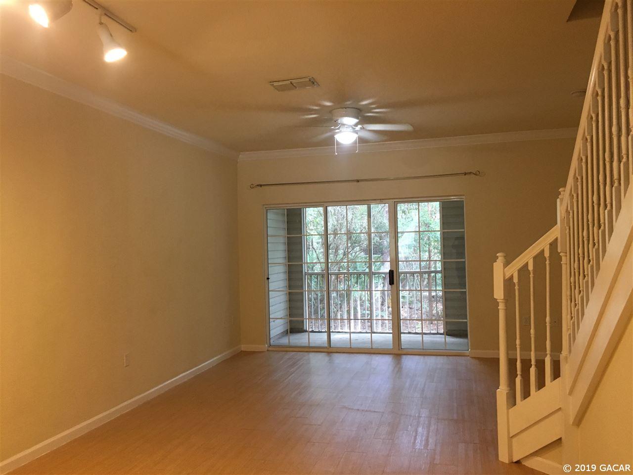 5065 Northwest 45th Road, Unit 106 Gainesville, FL 32606 - Photo 2 of 17 Looking out toward the doors to screened porch.