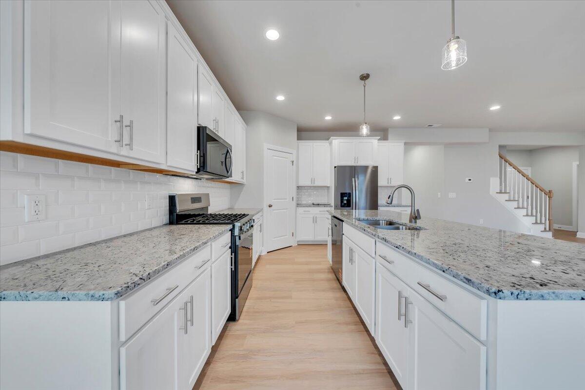 7168 Pkwy Vw Trail Roanoke, VA 24018 - Photo 9 of 26 a large kitchen with stainless steel appliances kitchen island a large counter top a stove and a sink