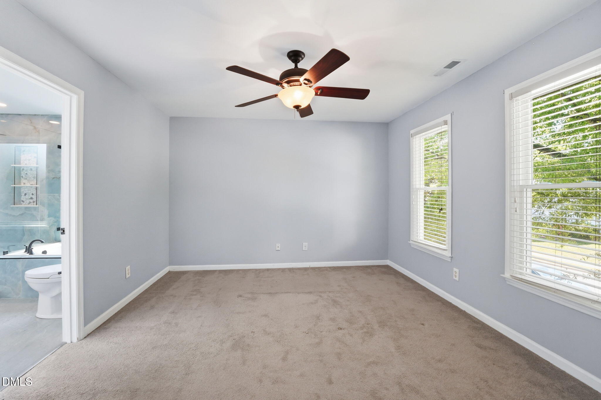2201 Roswell Road Raleigh, NC 27615 - Photo 16 of 32 a view of empty room with wooden floor and fan