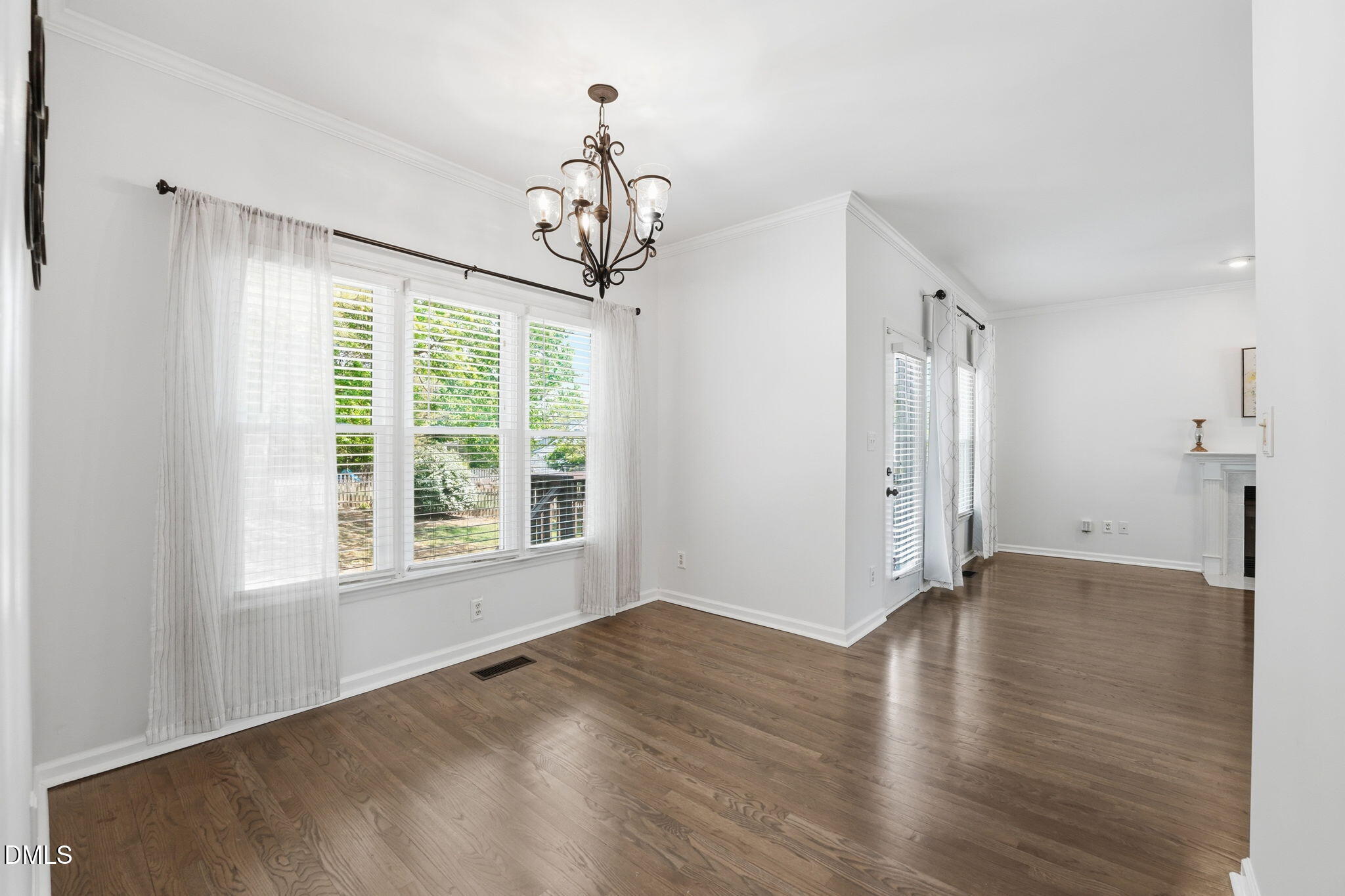 2201 Roswell Road Raleigh, NC 27615 - Photo 7 of 32 a view of an empty room with wooden floor and a window