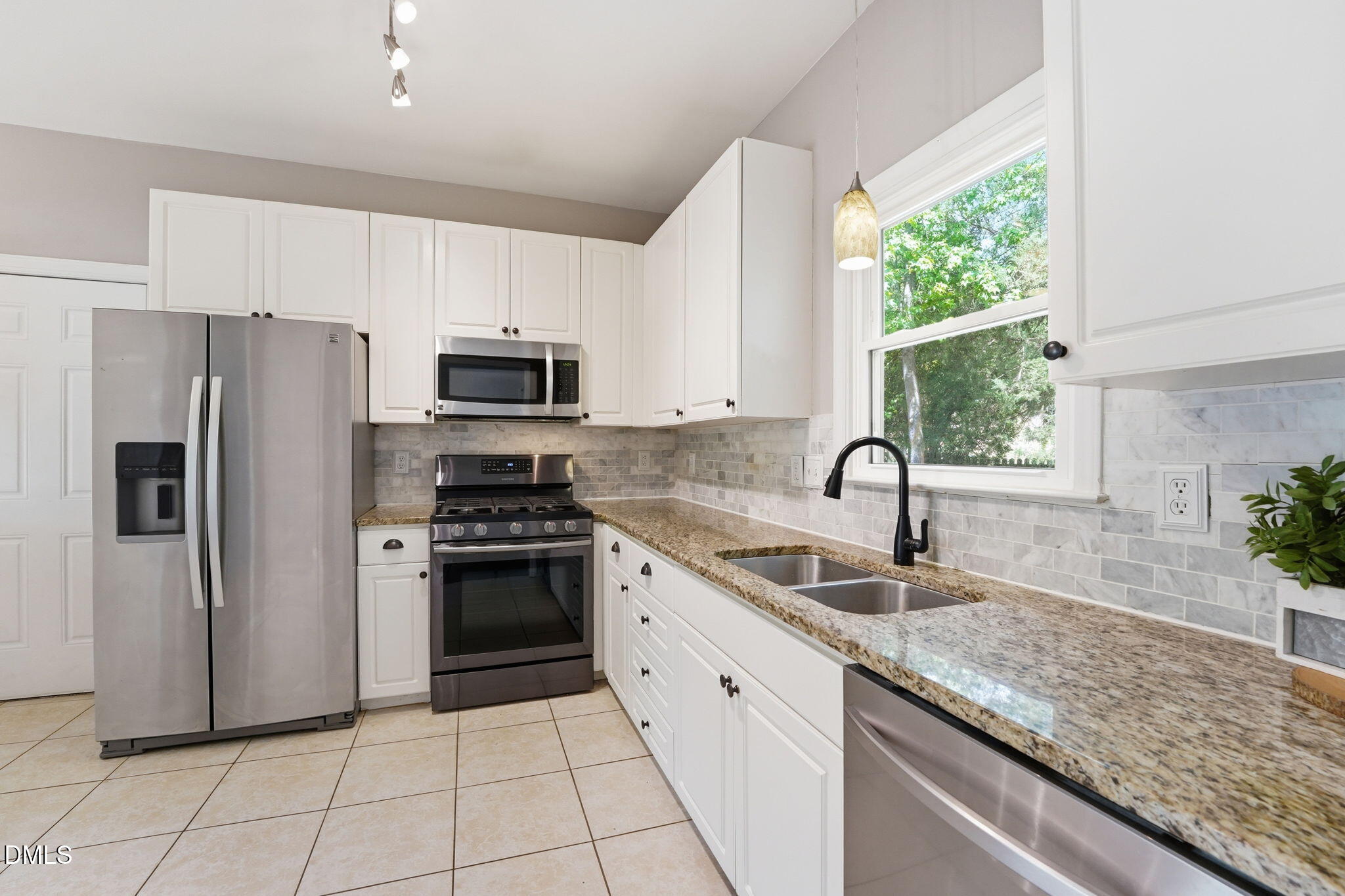 2201 Roswell Road Raleigh, NC 27615 - Photo 8 of 32 a kitchen with granite countertop a stove sink and refrigerator