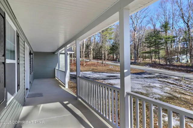 a kitchen with granite countertop a stove a sink and white cabinets