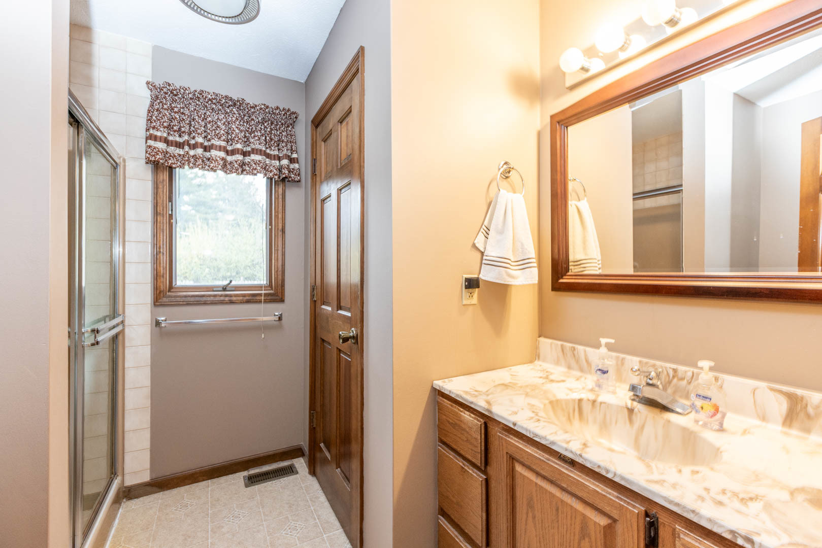 19051 Meander Way Bloomington, IL 61705 - Photo 14 of 30 a bathroom with a granite countertop sink and a mirror