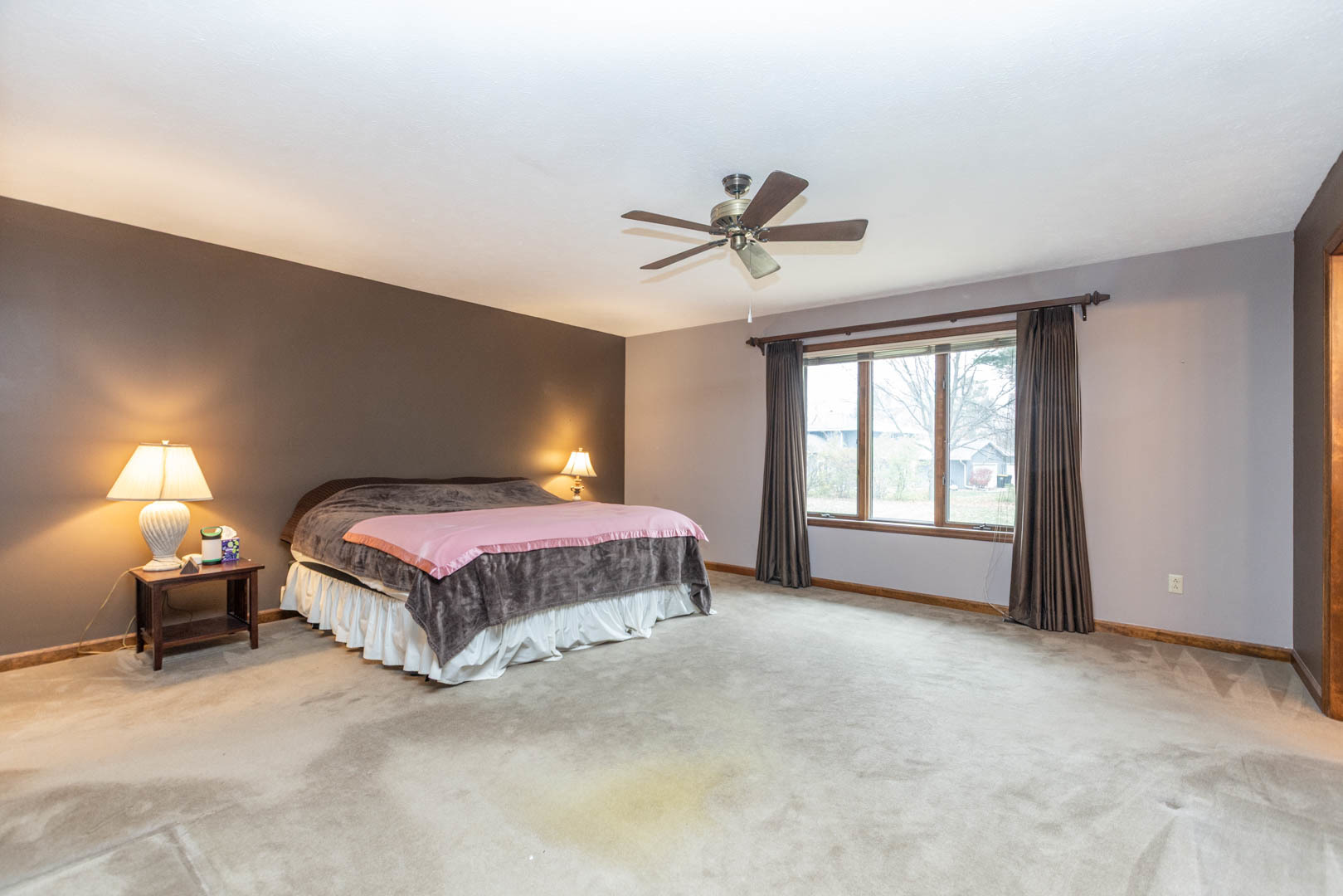 19051 Meander Way Bloomington, IL 61705 - Photo 15 of 30 a spacious bedroom with a bed and a chandelier