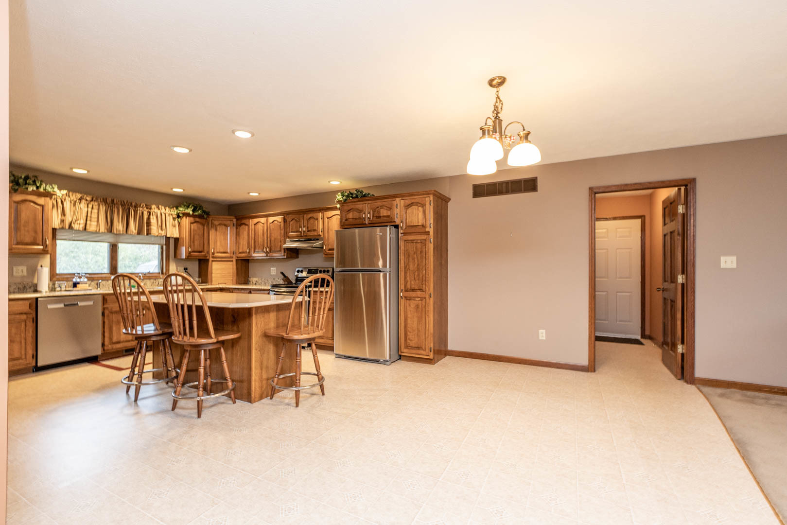 19051 Meander Way Bloomington, IL 61705 - Photo 9 of 30 a view of a dining room with furniture and a chandelier