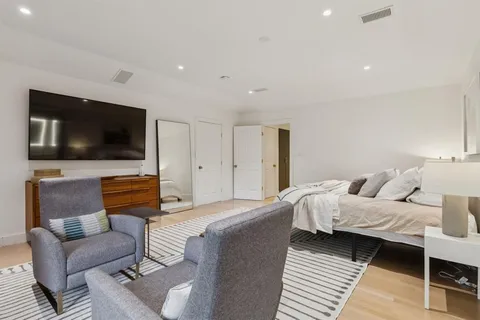 a bedroom with a bed and a flat screen tv