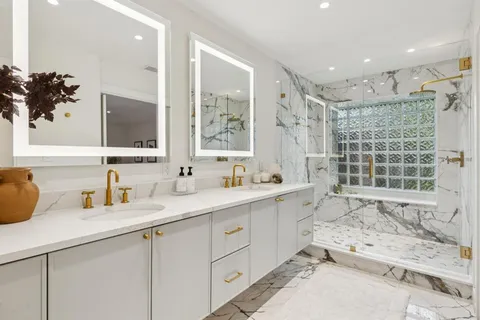 a bathroom with a granite countertop sink mirror and double