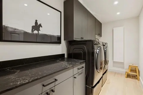 a close view of a sink a washer and dryer