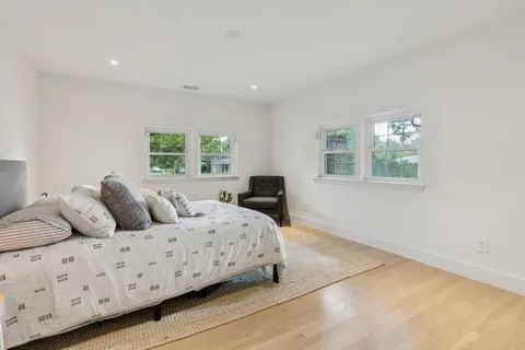 a large bedroom with a bed and a window