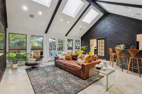 a living room with furniture and large windows