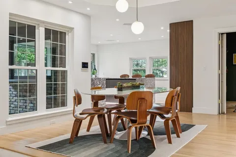 a dining room with furniture and wooden floor
