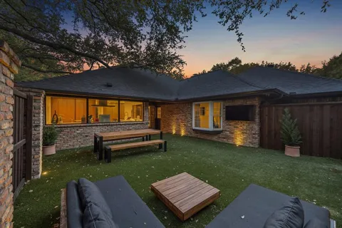 a view of a house with backyard and a patio